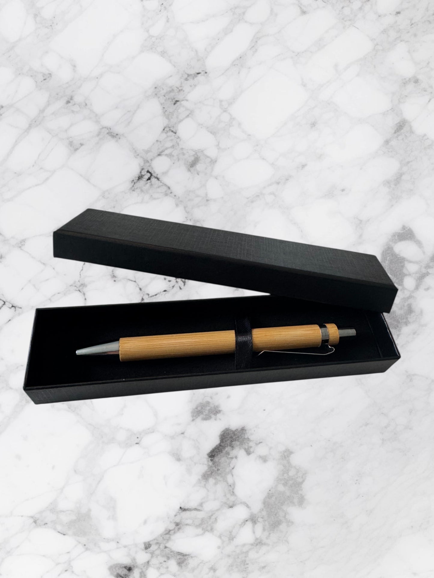 Sleek bamboo ballpoint pen with bullet tip and black ink. Eco-friendly, stylish, and smooth writing.