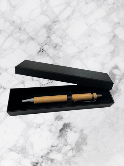 Sleek bamboo ballpoint pen with bullet tip and black ink. Eco-friendly, stylish, and smooth writing.