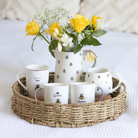 Bee Keeper White Ceramic Mug with bee motif on wicker tray.