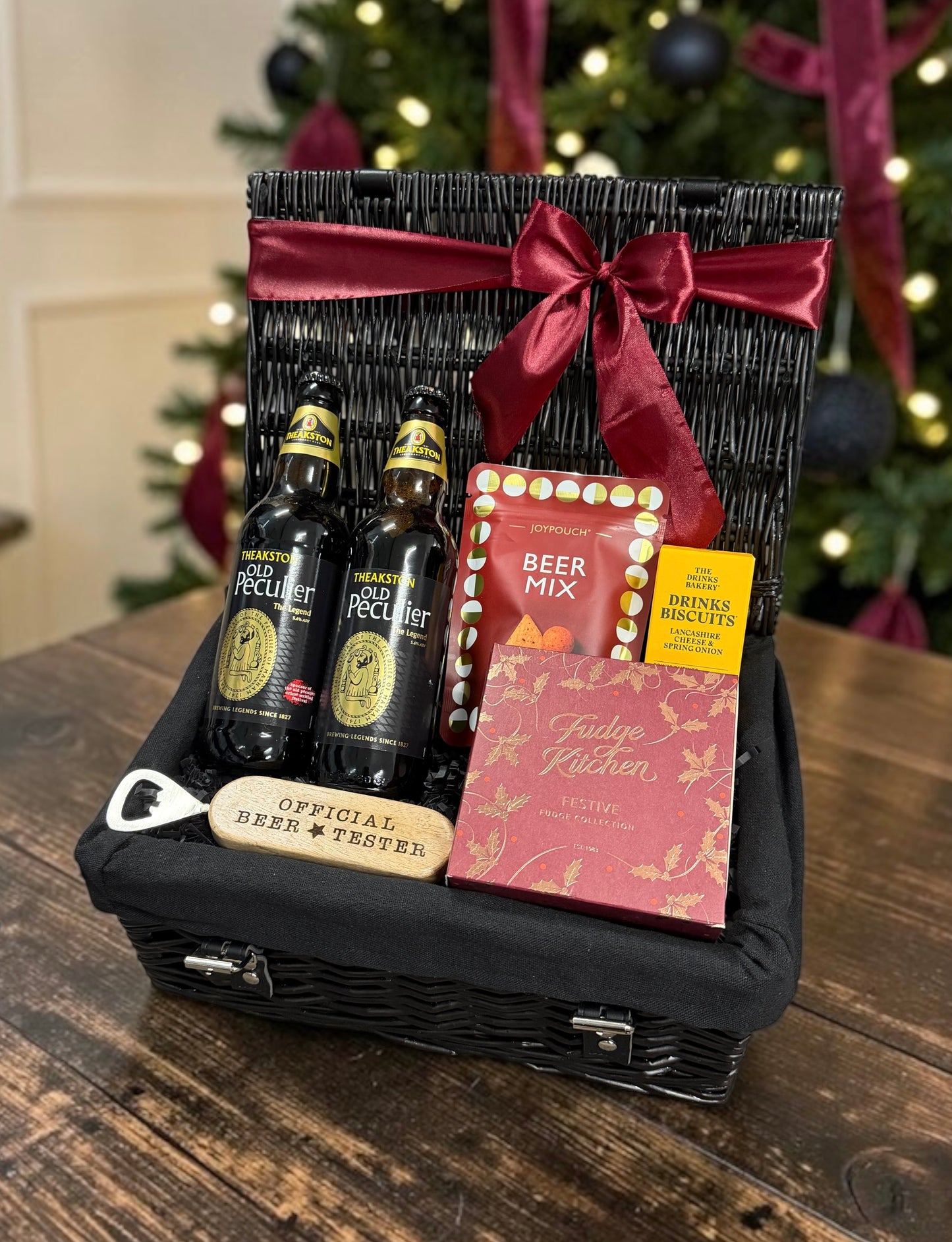 Beer and Festive Treats Hamper with a choice of Theakston or Birra Moretti, a beer tester bottle opener, snacks and festive fudge. A fun Christmas gift.