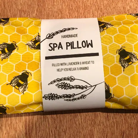 Bees Heatable Lavender and Wheat Spa Pillow in yellow bee-patterned fabric.