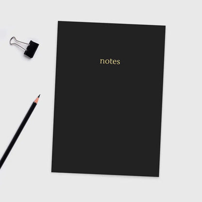 Black A5 Colourblock Notebook with gold foil 'notes' lettering, sleek design with colored paper edges.