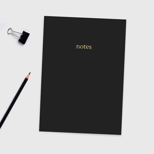 Black A5 Colourblock Notebook with gold foil 'notes' lettering, sleek design with colored paper edges.