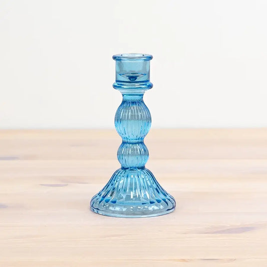 Blue glass pillar candle holder with unique design and sturdy composition, 15cm.