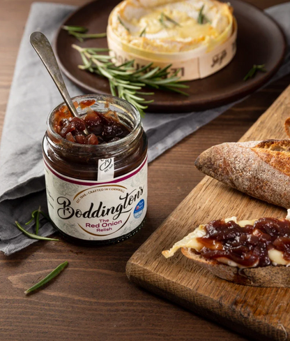 Bodgenton's Red Onion Relish jar with bread and cheese on a wooden board