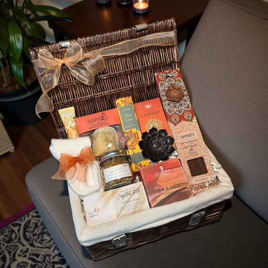 Boho relaxation gift hamper with fluffy socks, hand cream, crystal kit, bath salts, incense sticks with lotus holder, room spray and candles.