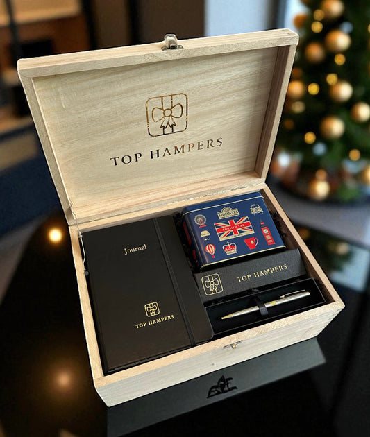 Luxury gift set with branded journal, Parker pen in box, English tea canister, arranged in a wooden gift box.
