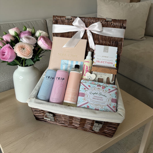 Break up self-care gift box with planner, chocolates, tea, body mist, diffuser refill and supportive keepsake.