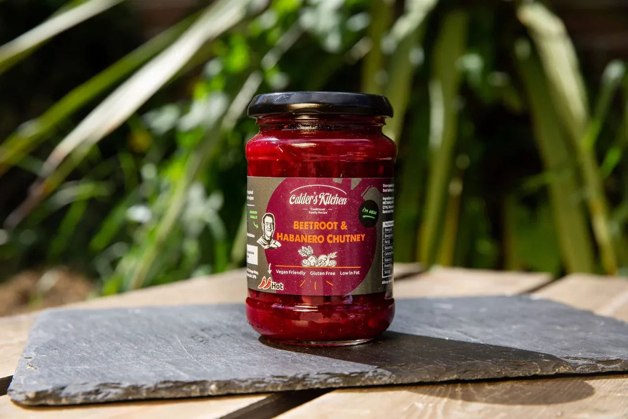 Award Winning Beetroot & Habanero Chutney jar on slate with greenery background.