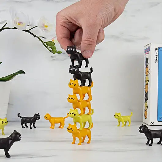 Cat-Astrophe Game with colorful cat figures stacked.