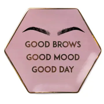Ceramic hexagon trinket dish with pink and gold "Good Brows" design.