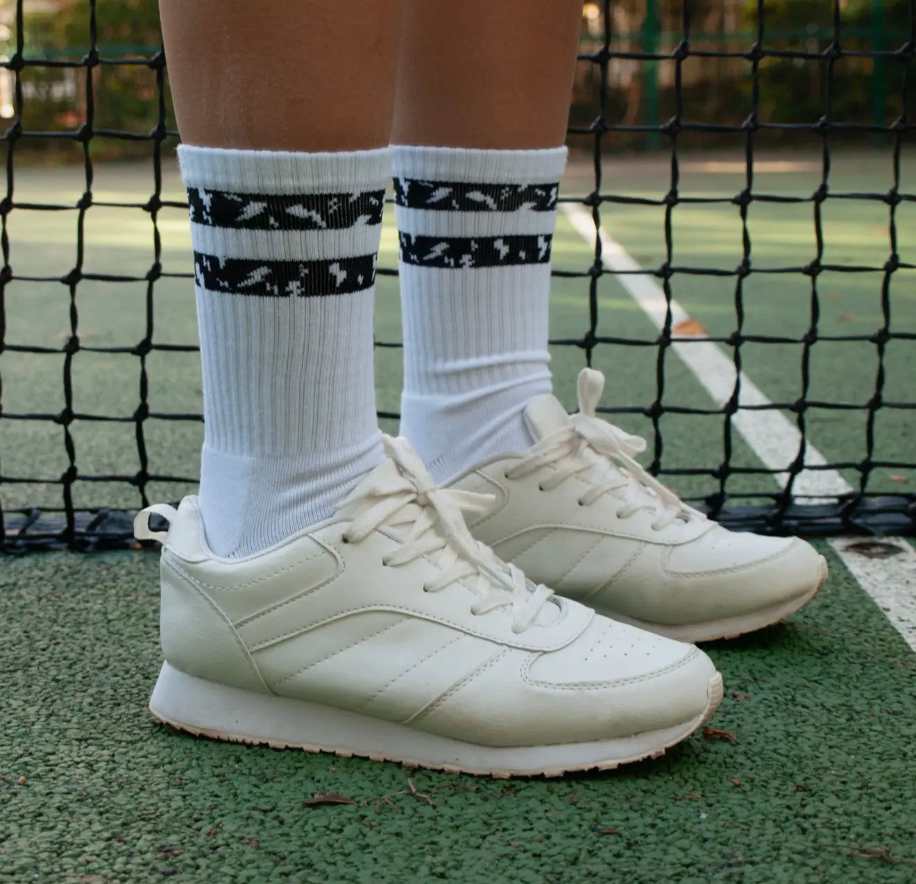 Charged up padel or tennis crew socks In white with black design, unisex and two sizes available 