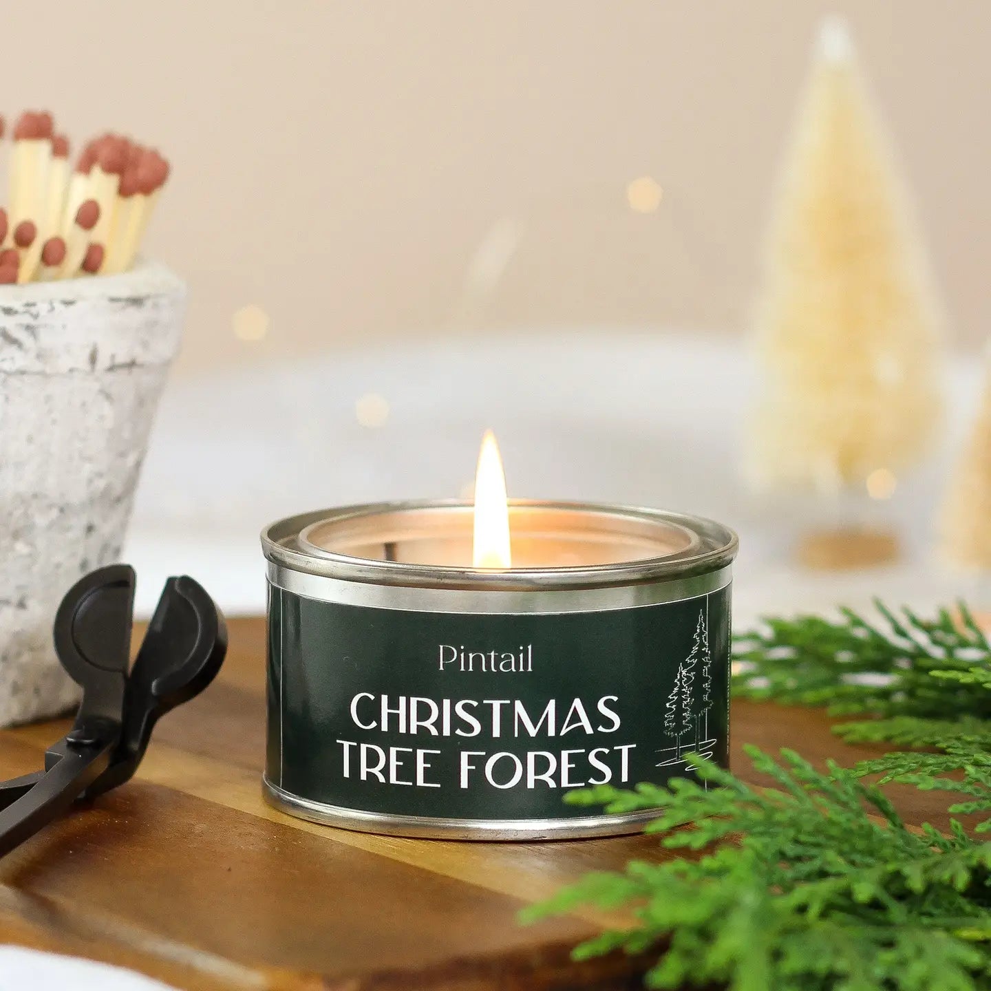 Christmas Tree Forest Paint Pot Candle, hand-poured in the Lake District, with fresh pine, wood, and sap notes evoking a snowy evergreen forest.
