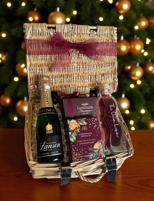 Christmas Mini Champagne Hamper featuring Lanson Champagne miniature, Christmas wreath candle, Hamiltons chocolates, and Oxton Raspberry Vodka.