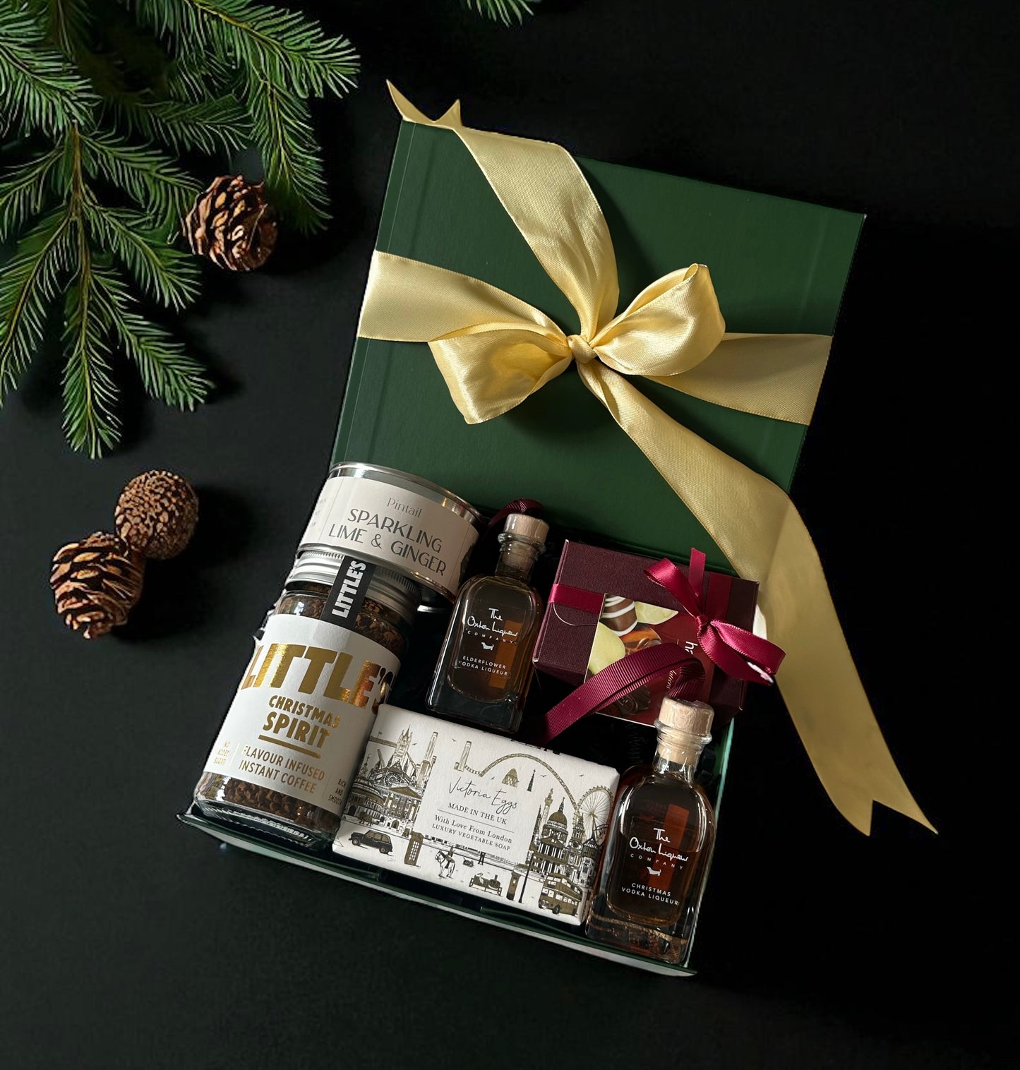 Christmas Treat Box featuring Christmas liqueur baubles, Hamiltons chocolate miniatures, Christmas Spirit coffee, lime & ginger candle, and London Soap.