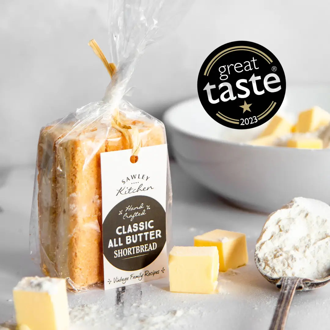 Classic all butter shortbread Yorkshire biscuits in packaging with Great Taste 2023 award, surrounded by butter and flour.