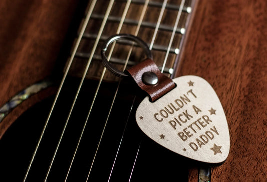 Better Daddy Wooden keyring in guitar pick shape with leather strap and silver ring.