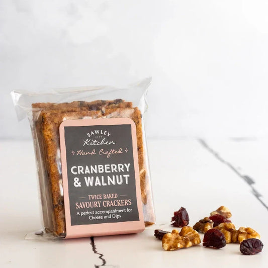 Artisan cranberry and walnut savoury crackers in a clear bag with hand-tied label, perfect for cheese pairings.