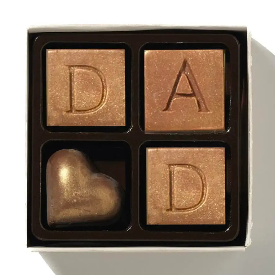 Handmade Belgian chocolate Dad letters dusted with gold with white and dark chocolate hearts.
