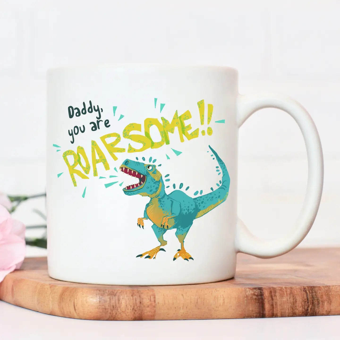 "Daddy You Are Roarsome" dinosaur-themed ceramic mug with hand-drawn illustration.