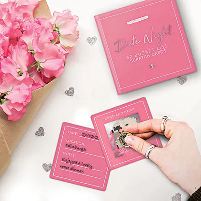Date Night scratch card game with pink cards and scratch-off panels, featuring 52 mystery date ideas.