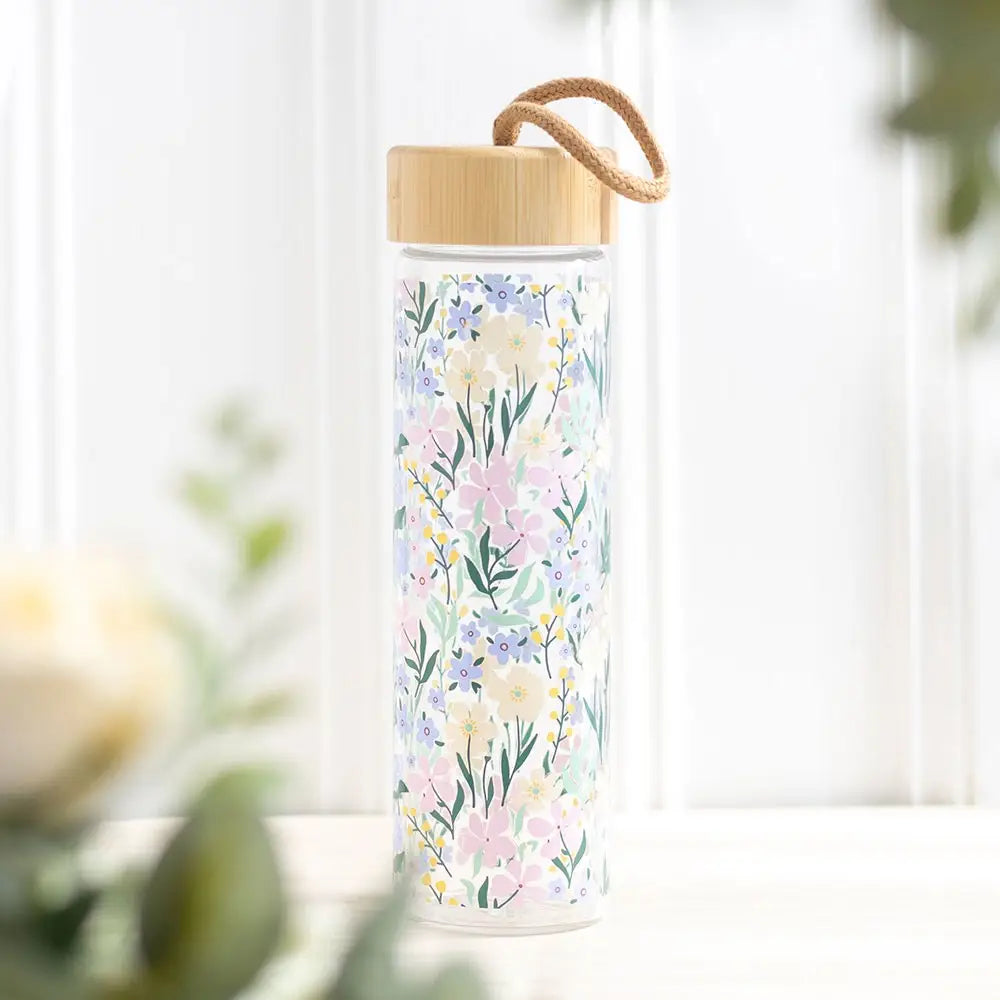 Ditsy floral print glass and bamboo water bottle with 550ml capacity.