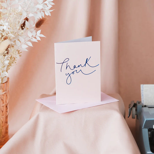 Thank You card with metallic rose and navy foil design.