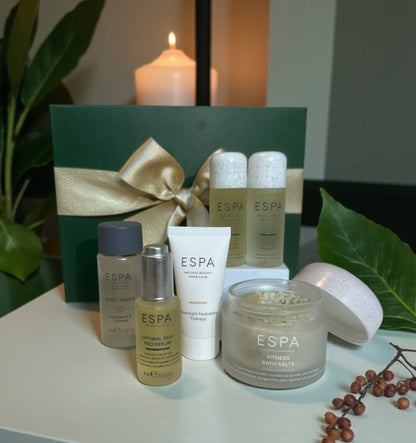 Espa skincare products on a table with a candle and decorative elements. Comes in a gift box. 