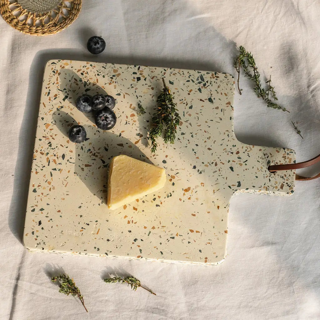Earthy terrazzo chopping board with leather strap adds charm and style to your rustic kitchen look.