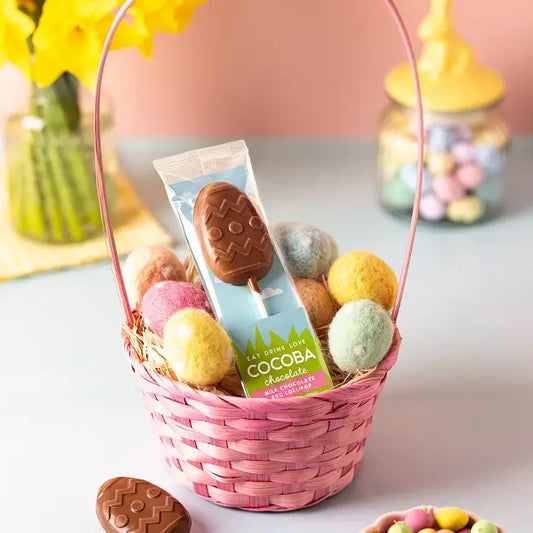 Milk Chocolate Easter Egg Lollipop in a festive basket with colorful eggs.