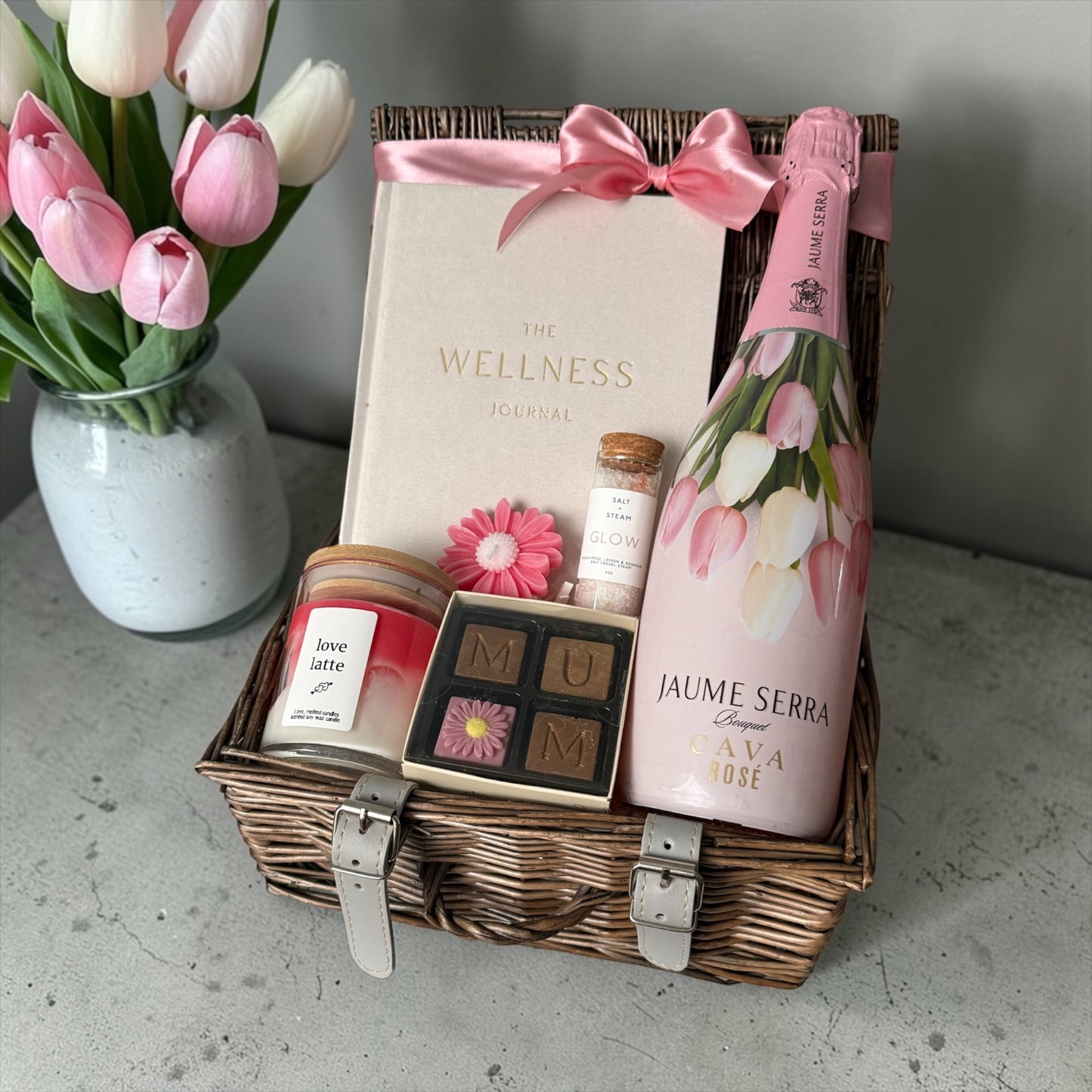 Luxury gift hamper for Mum with wellness journal, candle, chocolates and jaume serra cava rose, beautifully arranged.