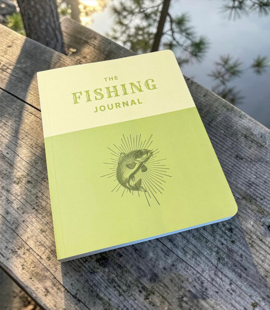 Fishing journal on a wooden surface with a natural background