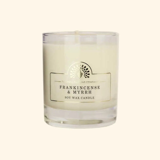 Enchanting Frankincense and Myrrh Soy Wax Candle with woody aroma in a glass jar.