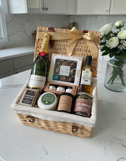 Gourmet appreciation hamper with garlic cheddar, rosemary crackers, cumin olives, chili oil, chocolates, preserves, candle, and wine options