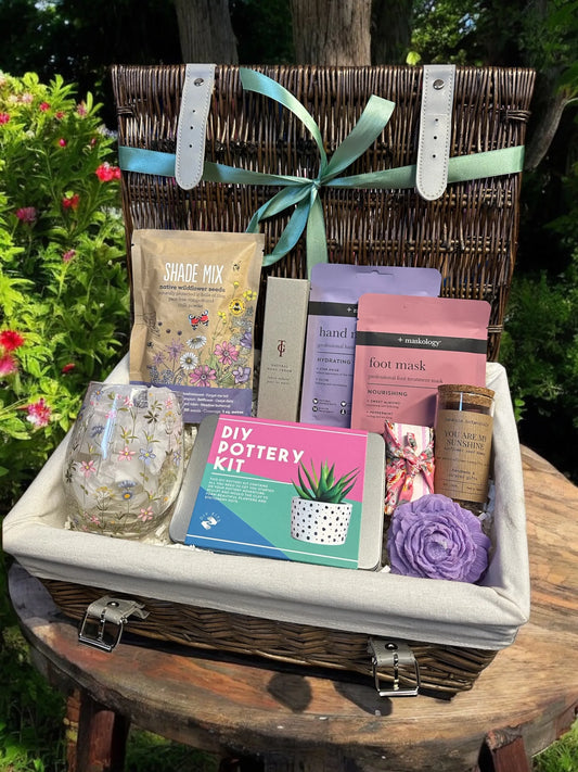 Garden and Craft Gift basket with DIY pottery kit, seeds, and self-care items.