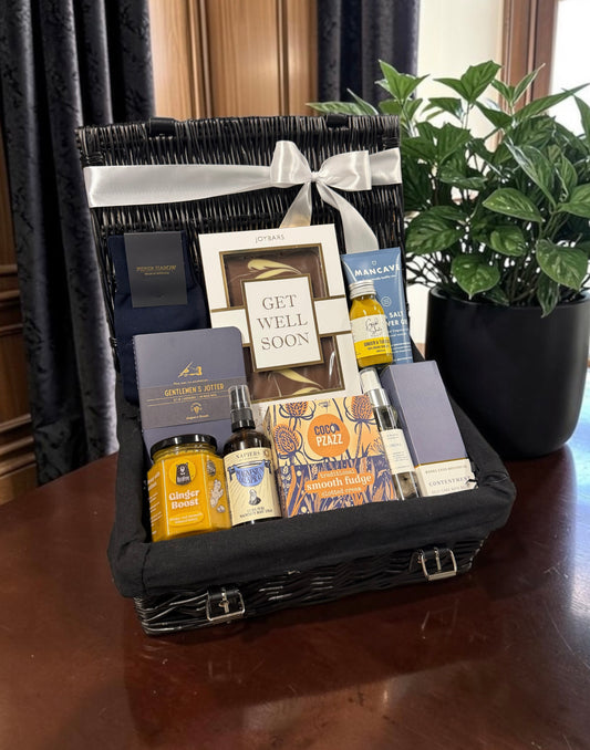 Gentlemen's Get Well Soon Hamper with a chocolate bar, notebook, magnesium spray, bath oil and fudge. A thoughtful gift to send comfort and care.