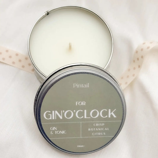 Gin O’Clock Candle in tin with lid displaying crisp botanical citrus scent.