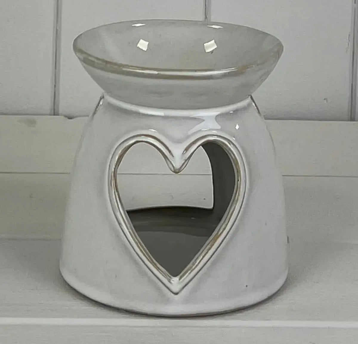 Glazed ceramic wax and oil burner with a heart cut-out. Soft glowing light and warm fragrance, a lovely gift for a new home, birthday or thank you.