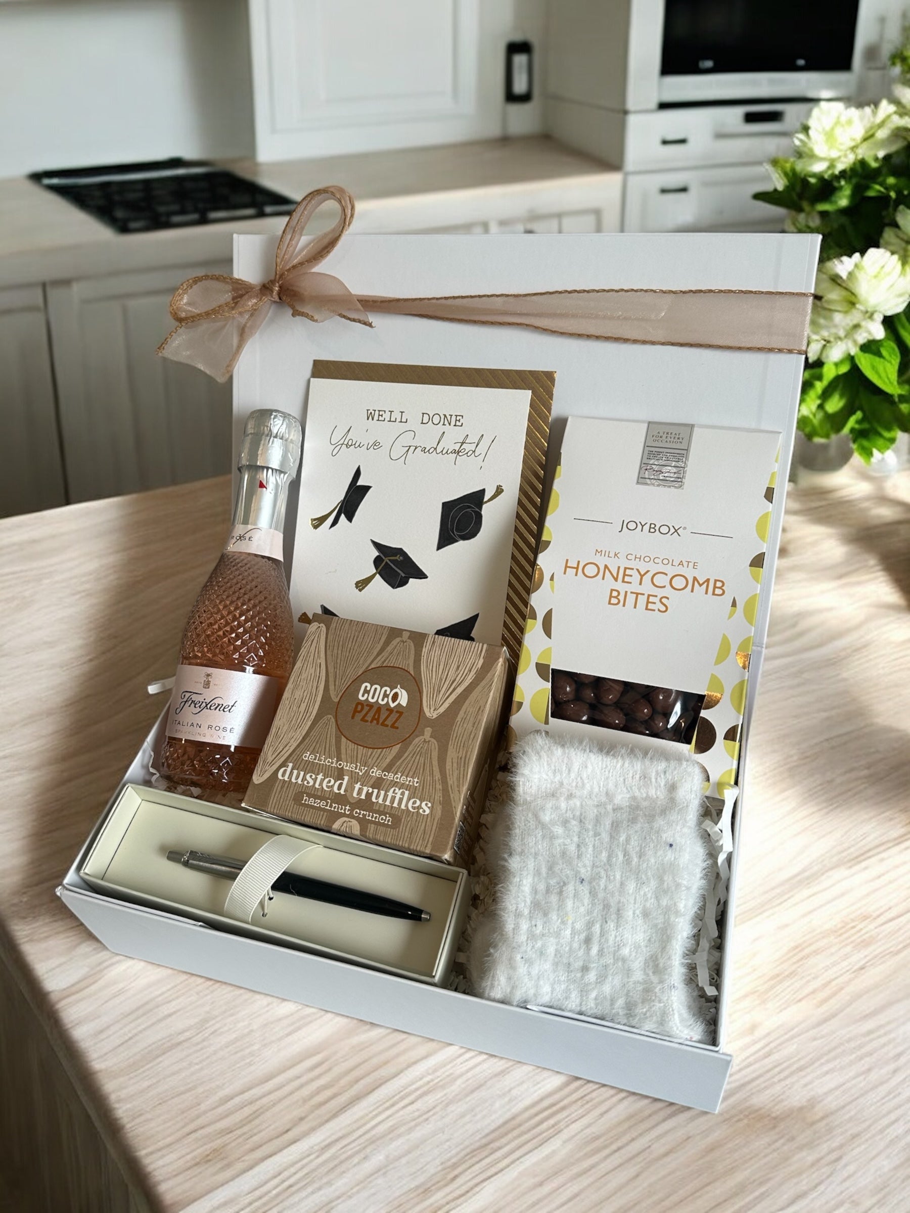 Graduation gift set for her with Freixenet Rose Prosecco, truffles, Parker pen, honeycomb bites, fluffy socks, and congratulatory card.