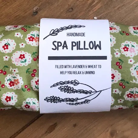 Heatable lavender and wheat spa pillow with a green blossom design.