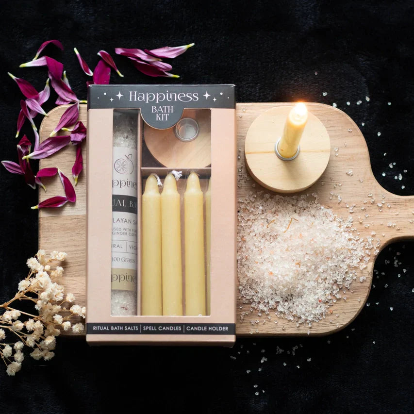 Happiness Herbal Ritual Bath Kit with natural vegan bath salts, lemon ginger aroma, yellow spell candles, and holder on wooden board.