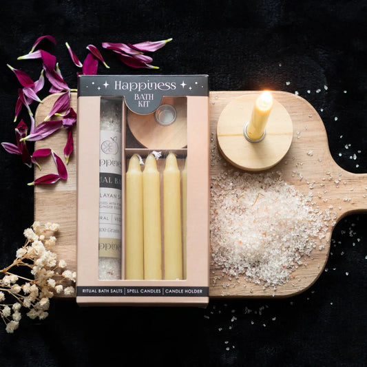 Happiness Herbal Ritual Bath Kit with natural bath salts, yellow spell candles, and holder on a wooden board.