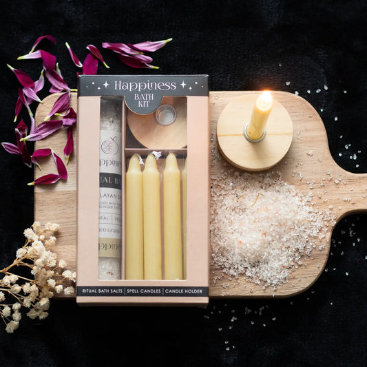 Happiness Herbal Ritual Bath Salt Kit with yellow spell candles and Himalayan salt.