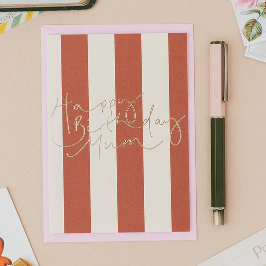 Happy Birthday Mum greetings card with gold foil lettering, blush pink striped design and matching pink envelope.