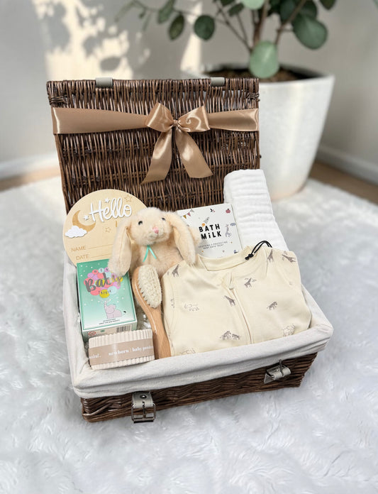 Hello World New Baby Hamper with a safari print sleepsuit, bath milk, a cuddly bunny and a Hello milestone plaque. A thoughtful new baby gift.