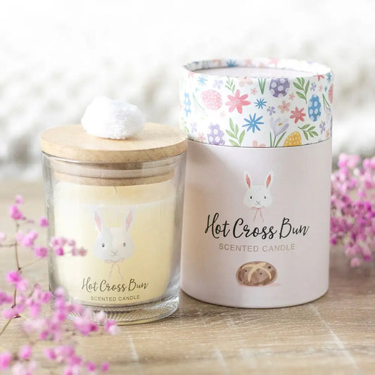 Hot Cross Bun Easter candle with bunny design and pom pom lid, perfect for spring gifting.