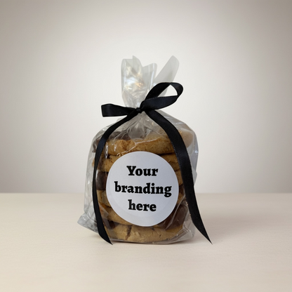 Bag of cookies with a black ribbon and customizable label on a light background