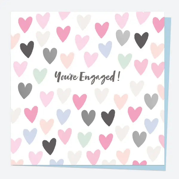 Elegant foil engagement card with a delicate love heart pattern—luxury for their special day.