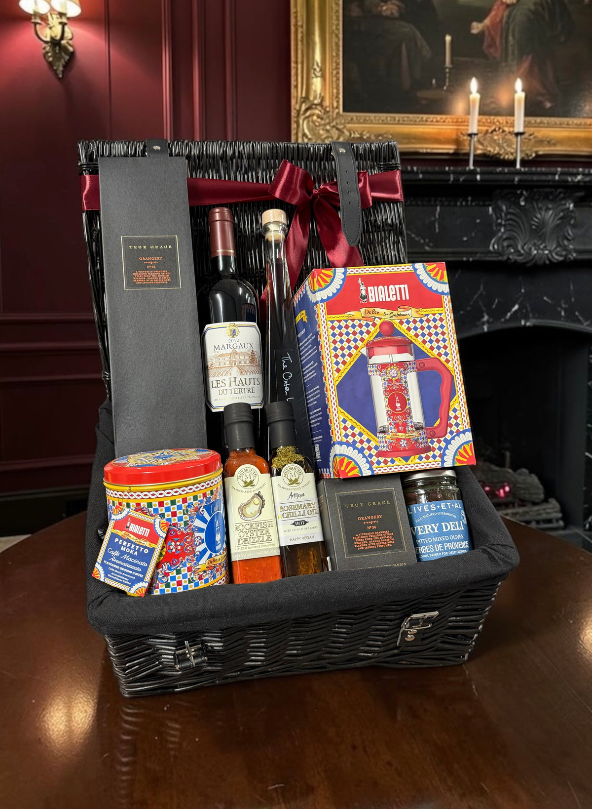 Luxury Connoisseurs Hamper with a choice of red wine, a Dolce & Gabbana Bialetti coffee maker, gourmet oils and a scented candle. An elegant gift.
