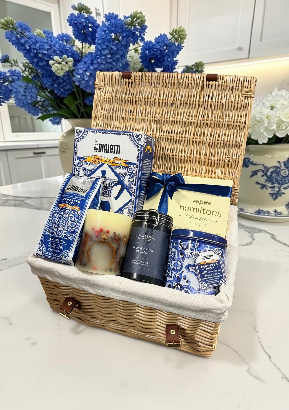 Luxury D&G Coffee Hamper with a Bialetti moka pot, ground coffee, a keepsake tin, ginger biscuits and Hamiltons chocolates. An elegant coffee lover's gift.